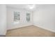 Carpeted bedroom featuring two windows, ceiling fan, and white walls at 225 S South Shore Ter, Fayetteville, GA 30214