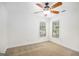 Bedroom featuring a ceiling fan, two windows, and plush carpeting at 225 S South Shore Ter, Fayetteville, GA 30214