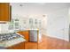 Open-concept kitchen with granite countertops, stainless steel appliances, and hardwood floors at 225 S South Shore Ter, Fayetteville, GA 30214