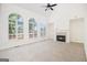 Bright living room with fireplace, carpet floors, and large arched windows with scenic backyard views at 225 S South Shore Ter, Fayetteville, GA 30214