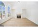 Cozy living room with a fireplace, large arched window and high vaulted ceilings at 225 S South Shore Ter, Fayetteville, GA 30214