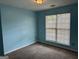 Light blue bedroom with carpet floors and a window letting in natural light at 95 Revere Turn Drive, Fairburn, GA 30213