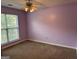 Bedroom with wall to wall carpet, a ceiling fan and a window overlooking the yard at 95 Revere Turn Drive, Fairburn, GA 30213