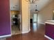 View from dining room into an open living room with fireplace and hardwood floors at 95 Revere Turn Drive, Fairburn, GA 30213