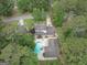 Aerial view of the property showcasing a swimming pool surrounded by lush greenery and mature trees at 112 Kirton Turn, Peachtree City, GA 30269