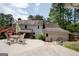 Backyard patio area with table and chairs and a view of the home's rear elevation at 112 Kirton Turn, Peachtree City, GA 30269