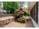 A view of the side of the house with a Japanese maple and terraced stone wall at 112 Kirton Turn, Peachtree City, GA 30269