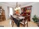 Elegant dining room with laminate floors, chandelier lighting, and a beautiful display cabinet at 112 Kirton Turn, Peachtree City, GA 30269