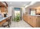 Spacious kitchen featuring tiled floors, natural light, and a breakfast bar at 112 Kirton Turn, Peachtree City, GA 30269