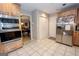 Modern kitchen with tile flooring, wood cabinets, stainless steel appliances, and ample storage at 112 Kirton Turn, Peachtree City, GA 30269