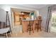 View of the kitchen and breakfast bar from the living room, filled with natural light at 112 Kirton Turn, Peachtree City, GA 30269