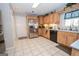 Kitchen with stainless steel appliances, light wood cabinets, and tile flooring at 112 Kirton Turn, Peachtree City, GA 30269