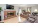 Inviting living room with a brick fireplace, laminate flooring, and a cozy seating arrangement at 112 Kirton Turn, Peachtree City, GA 30269