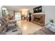 Bright and airy living room with laminate floors, fireplace, and access to the outdoor patio at 112 Kirton Turn, Peachtree City, GA 30269