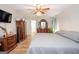 Spacious main bedroom featuring a ceiling fan, wood flooring, and an ensuite bathroom at 112 Kirton Turn, Peachtree City, GA 30269