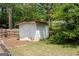 Backyard view of a storage shed with green grass and landscaping at 112 Kirton Turn, Peachtree City, GA 30269