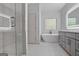 Luxurious bathroom features a glass shower, soaking tub, and double vanity with LED mirrors at 1155 Graystone Xing, Alpharetta, GA 30005