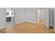 Bright bedroom featuring wood floors, white walls, and doorways leading to other areas at 1155 Graystone Xing, Alpharetta, GA 30005