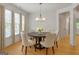 Elegant dining room features a modern chandelier, large windows, and a cozy round dining table at 1155 Graystone Xing, Alpharetta, GA 30005
