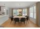 Bright dining room features a modern light fixture, table, and large windows at 1155 Graystone Xing, Alpharetta, GA 30005