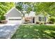 Charming home featuring a well-maintained front yard and an attached garage at 1155 Graystone Xing, Alpharetta, GA 30005