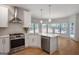 Modern kitchen featuring stainless steel appliances, quartz countertops, and natural light at 1155 Graystone Xing, Alpharetta, GA 30005
