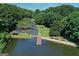 Scenic lake view with a pier and sitting area, surrounded by trees and greenery at 1155 Graystone Xing, Alpharetta, GA 30005