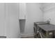 Functional laundry room features modern washer and dryer, cabinets, and storage shelves at 1155 Graystone Xing, Alpharetta, GA 30005