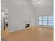 Open-concept living room featuring a modern fireplace and wood flooring at 1155 Graystone Xing, Alpharetta, GA 30005