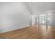 Open-concept living room with wood flooring, high ceilings, and large windows at 1155 Graystone Xing, Alpharetta, GA 30005
