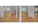 Bright, open-concept living room with wood flooring, featuring columns for definition at 1155 Graystone Xing, Alpharetta, GA 30005