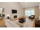 Stylish staged living room boasts a cozy fireplace, modern furniture, and ample natural light at 1155 Graystone Xing, Alpharetta, GA 30005