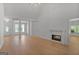 Spacious living room featuring wood floors, modern lighting, and a fireplace at 1155 Graystone Xing, Alpharetta, GA 30005