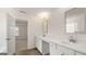 Bathroom featuring dual sinks, tile floors, and a linen closet at 1804 Quaker St, Hampton, GA 30228