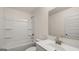 Bright bathroom with a shower-tub combo, a modern vanity with a large mirror, and updated fixtures at 1804 Quaker St, Hampton, GA 30228