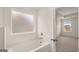 White soaking tub in bathroom with a window at 1804 Quaker St, Hampton, GA 30228