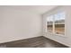 Bright empty bedroom with a dark floors, a window and fresh, neutral walls at 1804 Quaker St, Hampton, GA 30228