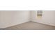Empty bedroom with neutral carpet, white walls, baseboards and natural light from the window at 1804 Quaker St, Hampton, GA 30228