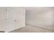 Neutral bedroom with a large closet door and a secondary door, featuring neutral carpet and paint throughout at 1804 Quaker St, Hampton, GA 30228
