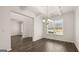 Dining area boasts dark flooring, coffered ceiling, modern chandelier, and ample natural light from window at 1804 Quaker St, Hampton, GA 30228