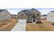 Two-story home with a brick and stone facade, two-car garage, and well-maintained lawn at 1804 Quaker St, Hampton, GA 30228