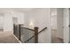 Bright hallway features carpet, staircase with a stained handrail, and access to multiple rooms at 1804 Quaker St, Hampton, GA 30228