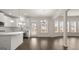 Bright, open-concept kitchen with white cabinets, stainless appliances, island and hardwood floors at 1804 Quaker St, Hampton, GA 30228