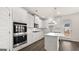 White kitchen with stainless appliances, island, and a double oven at 1804 Quaker St, Hampton, GA 30228