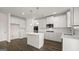 Kitchen with white cabinets, center island, stainless appliances and hardwood flooring at 1804 Quaker St, Hampton, GA 30228