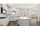 Well lit kitchen with white cabinets, island, stainless appliances and a bay window at 1804 Quaker St, Hampton, GA 30228