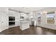 Modern kitchen with white cabinetry, stainless steel appliances, and wood floors at 1804 Quaker St, Hampton, GA 30228