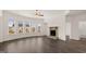 Bright living room with hardwood floors, stone fireplace, and large windows at 1804 Quaker St, Hampton, GA 30228