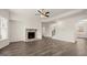 Spacious living room with fireplace, hardwood floors, and stairs at 1804 Quaker St, Hampton, GA 30228