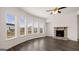 Bright living room with hardwood floors, stone fireplace, and large windows at 1804 Quaker St, Hampton, GA 30228